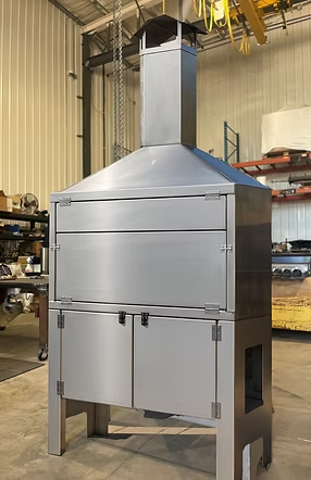 Stainless steel freestanding South African braai with glowing coals