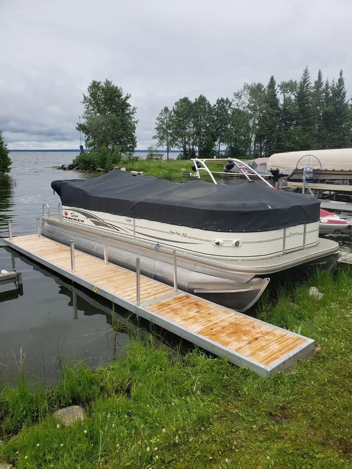 Aluminum walkway dock with cedar decking next to docked pontoon