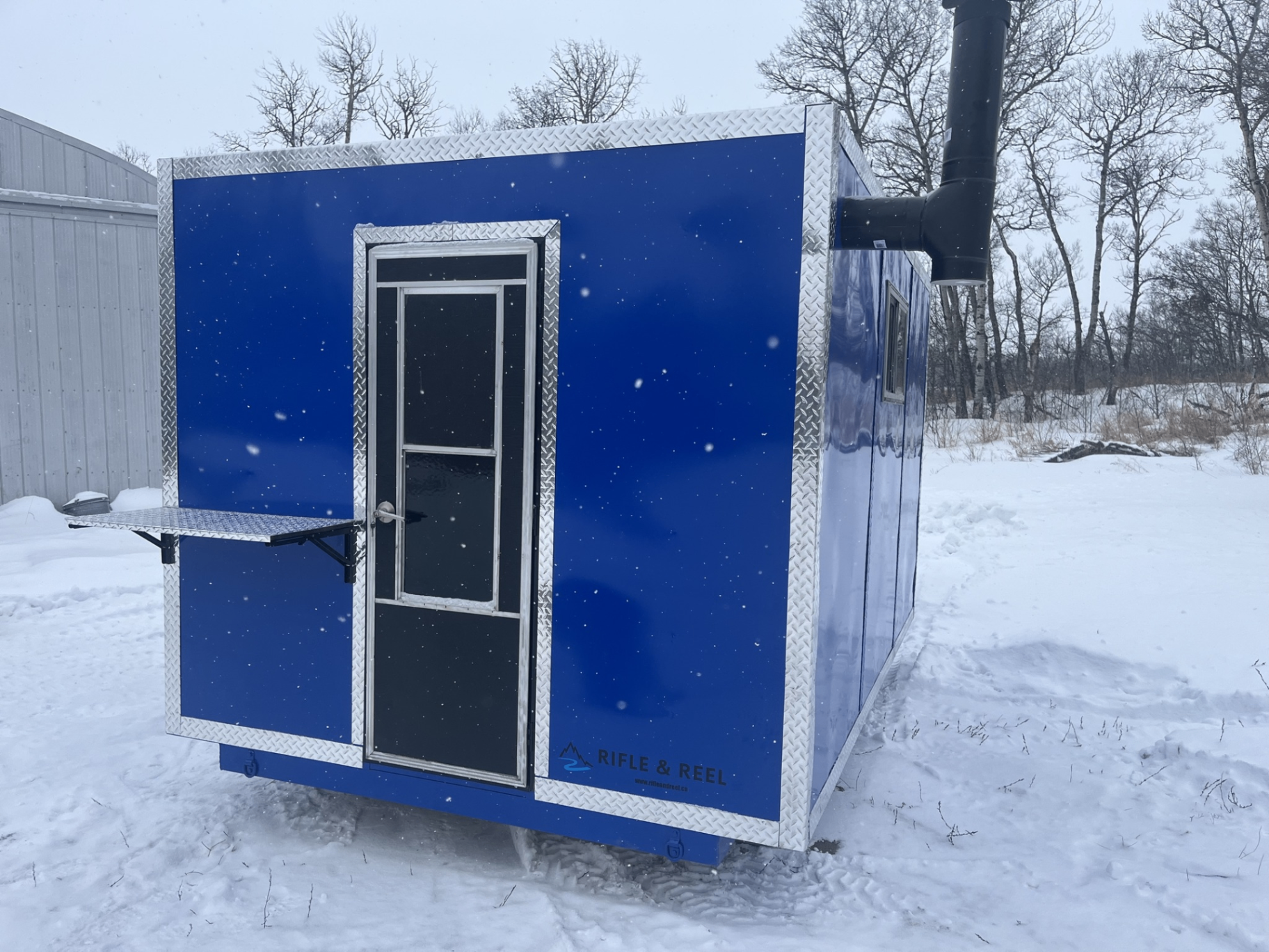 Front view of blue ice shack with door and fold-out shelf